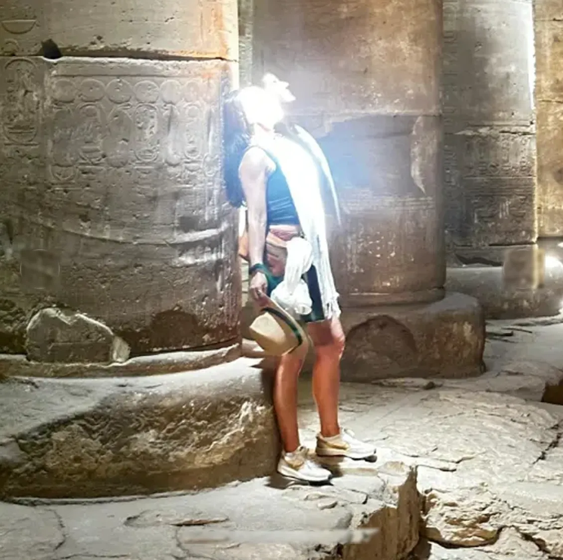 Participant in a beam of light among the columns at Abydos
