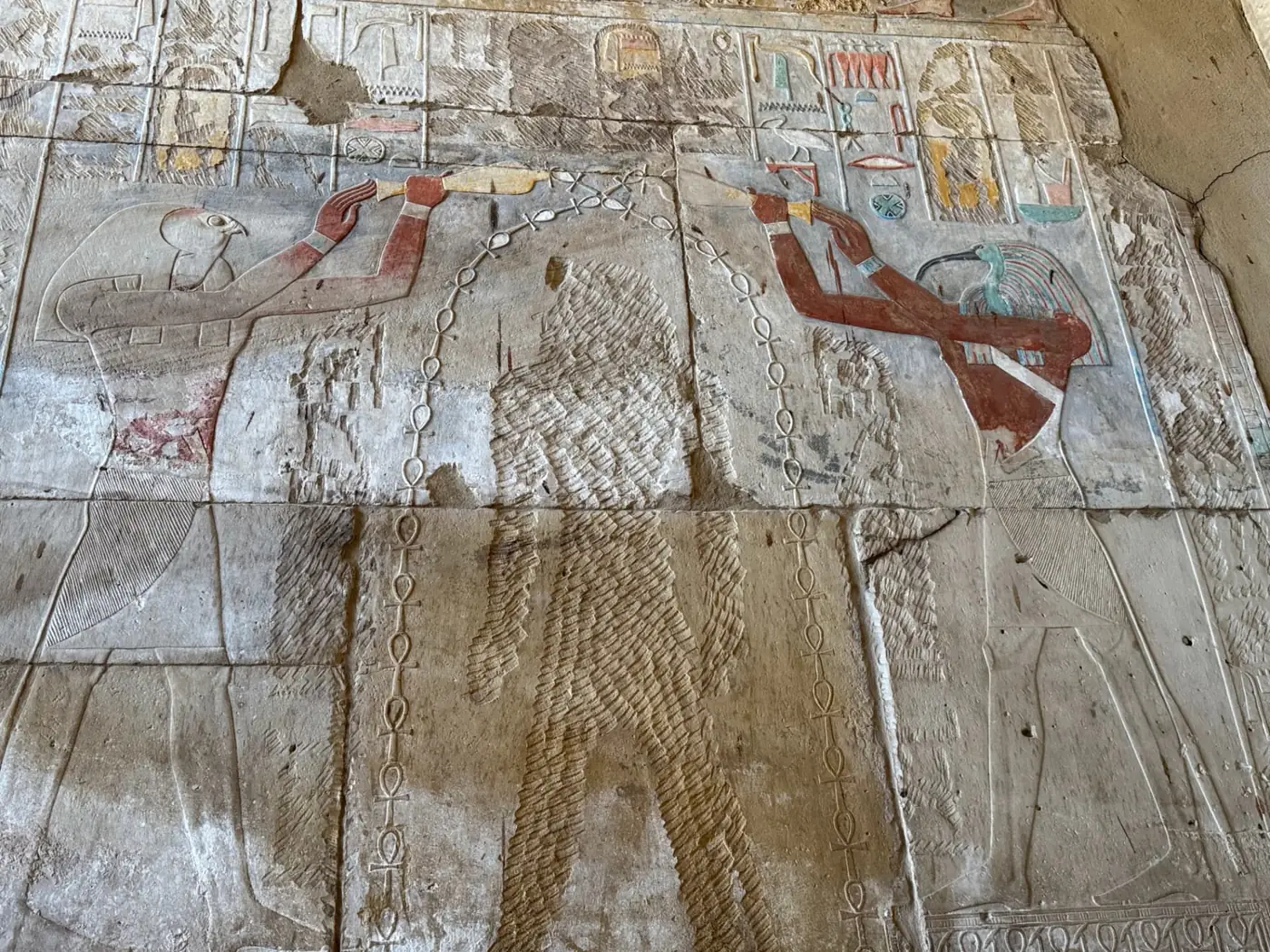 Painted hieroglyph relief on a wall of the Karnak Temple Complex in Luxor