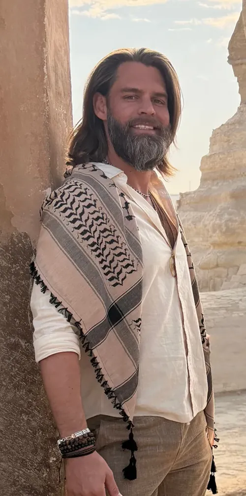 Brandon Yager standing beside the Sphinx in Egypt