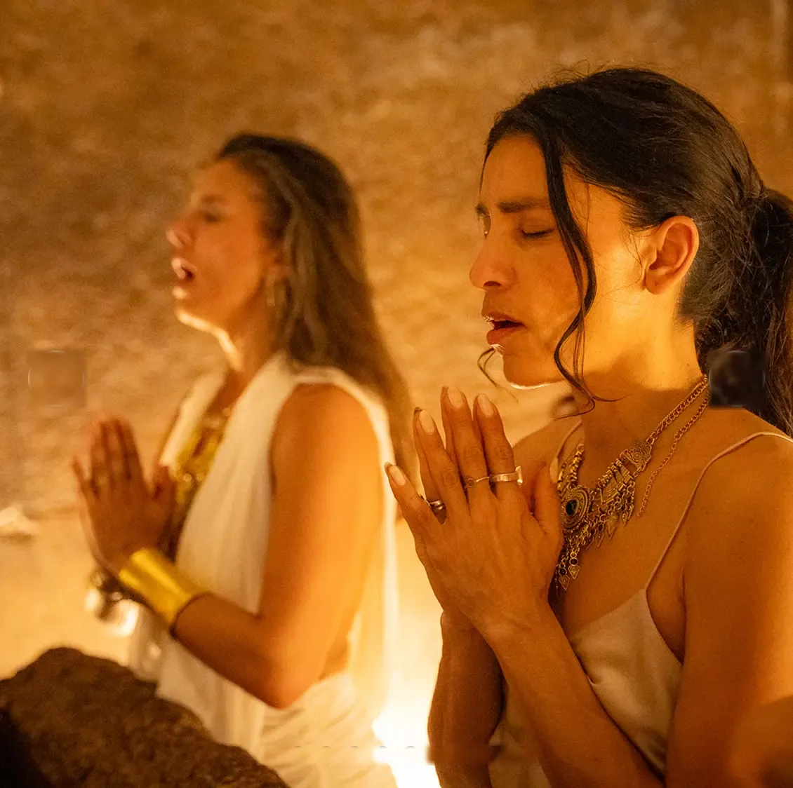 Two women in prayer inside the Great Pyramid chamber