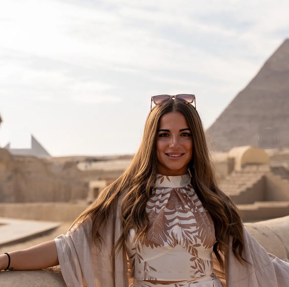 Participant on the Giza plateau with the pyramids behind her