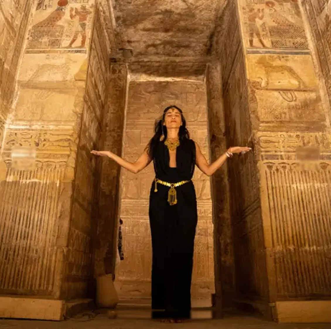 Woman with open arms inside the Temple of Hathor at Dendera