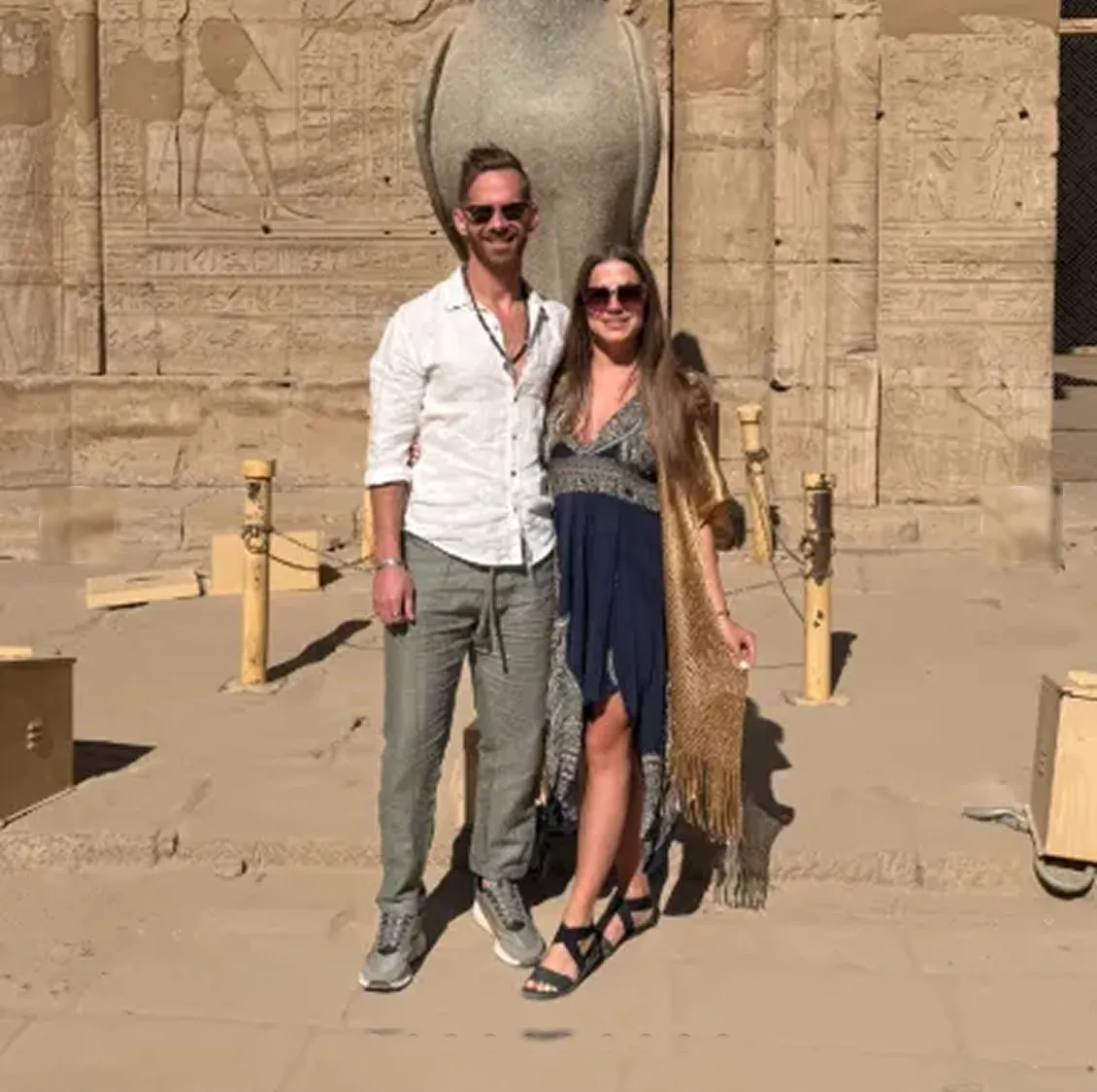 Couple before the Horus statue at the Temple of Edfu