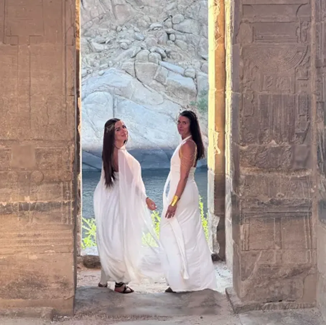 Two women in white in the doorway of Philae, Temple of Isis