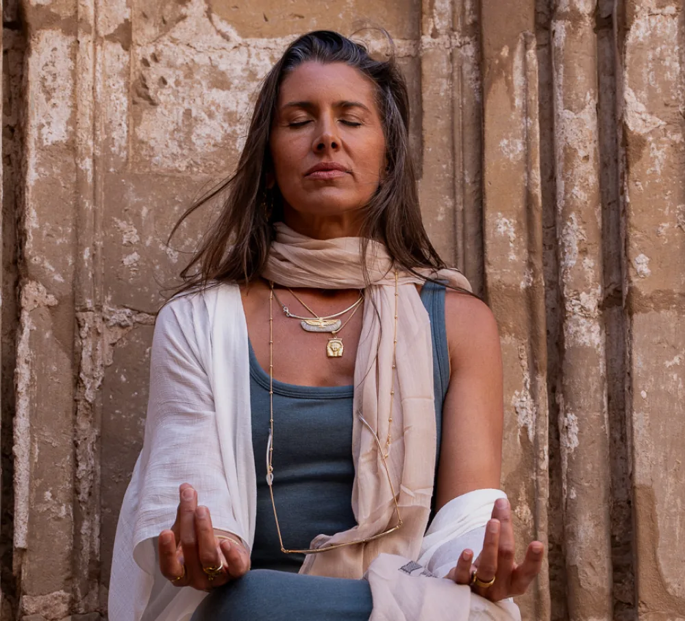 Deb Yager meditating beside the temple columns